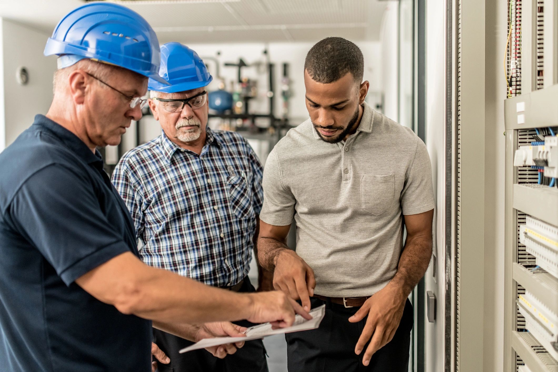 Engineering team reviewing technical documentation