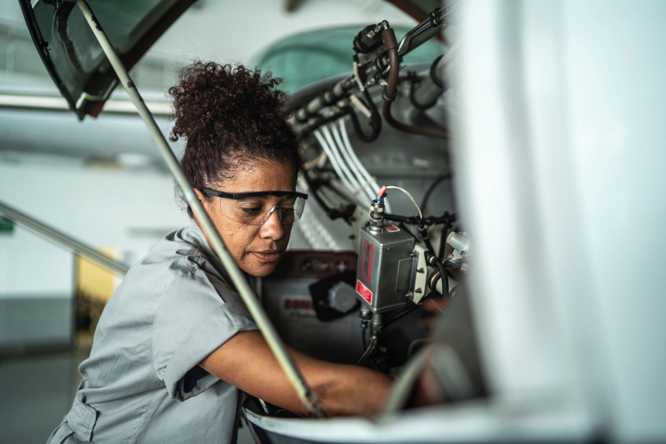 Technician working on aircraft systems in a hangar