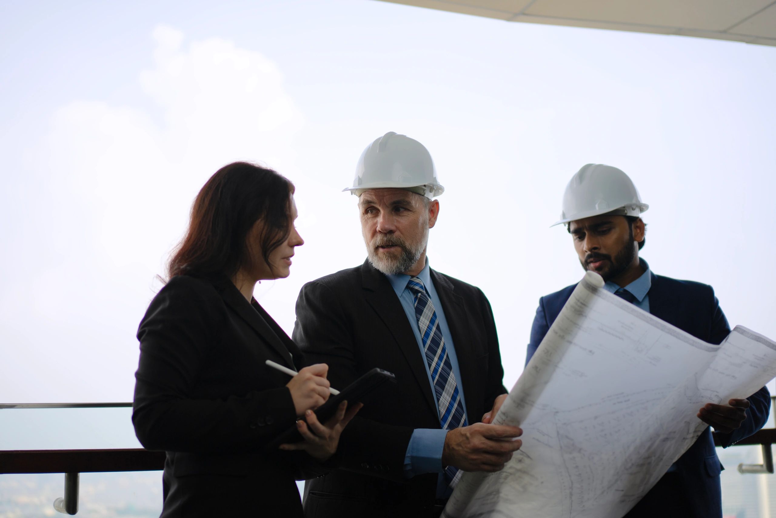 Engineering team reviewing technical drawings in an office setting