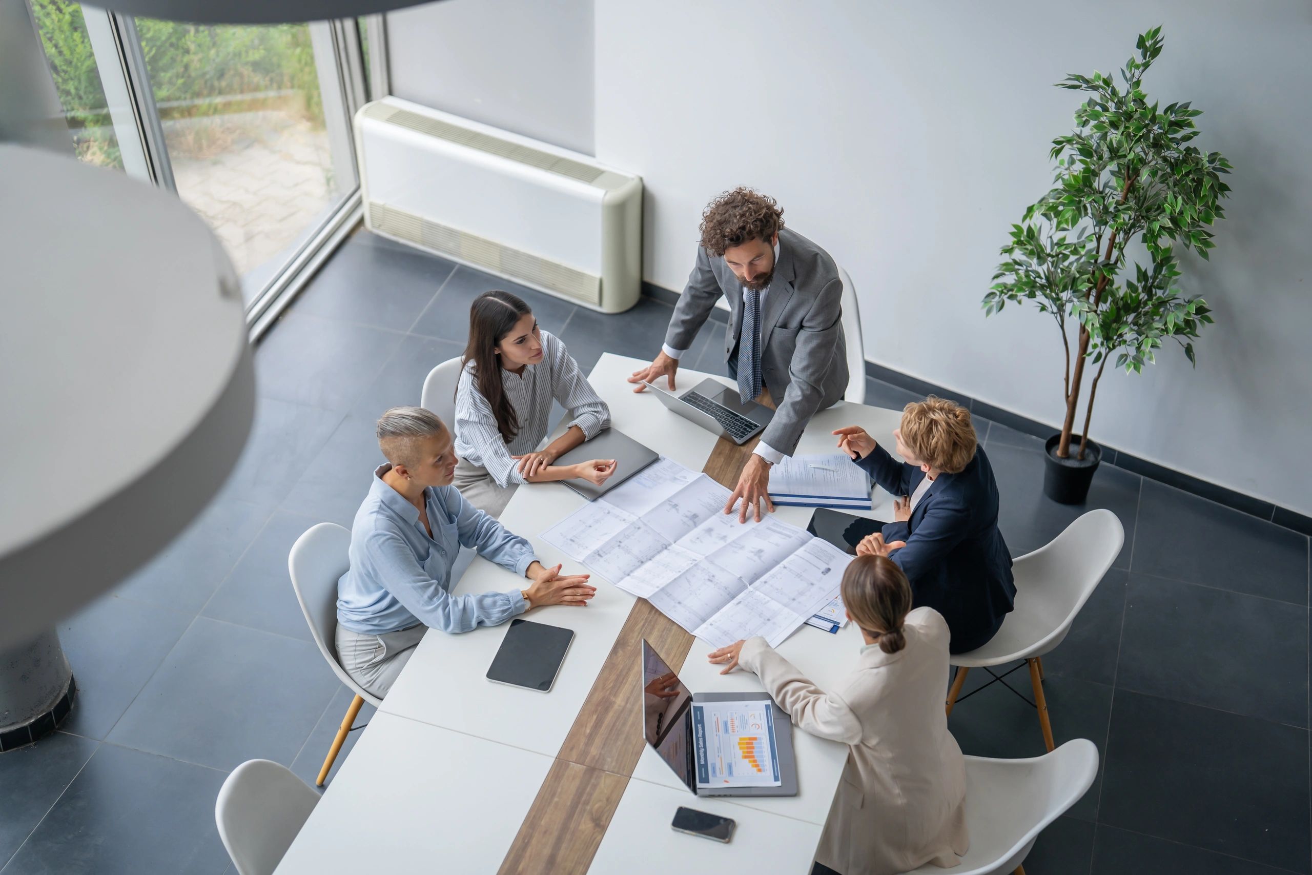 Engineering team reviewing technical drawings in a modern office